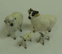 Beswick, black-faced ram, sheep, no.935 and two lambs, no.937. (4)
