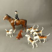 Beswick brown huntswoman together with 6 foxhounds and a seated fox.