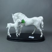 Beswick matt white mare and foal on a black wooden plinth 'Spirit of Affection'.