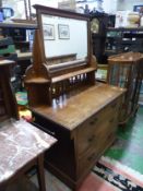 Arts & Crafts oak dressing chest of three drawers with tilting mirror above, raised on a plinth