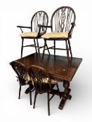 20th Century dark oak draw leaf table and 4 wheelback chairs (2 carvers). Carved pillar leg