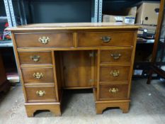 Reproduction yew twin pedestal desk with 8 drawers and a locking cupboard to the knee recess, tooled