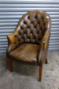 Button backed leather desk chair, in 'antique bronze' finish, W 62cm x H 103cm x D 68cm.