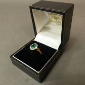 18ct yellow gold ring set with a central emerald surrounded by diamonds, size K/L, 3.12g.