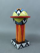 Lorna Bailey footed vase decorated in black, orange, red, blue and yellow on a white ground, signed,