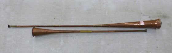 Two copper coaching horns, length of longest 126cm (2).