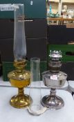 Brass oil lamp with chimney, together with a white metal oil lamp and chimney, no shades, height