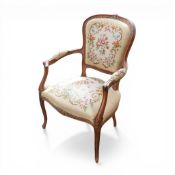 French style needlepoint oak framed armchair, on cabriole legs with decorative carved details.