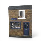 A ceramic diorama depicting an antique shop front. (H: 35cm)