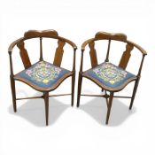 Early 20th century mahogany corner chairs, featuring a shaped back, scrolled arms, turned legs