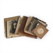 A vintage photograph album containing many black and white family photos, portraits etc