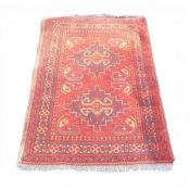 100% Wool Pile rug with recurring abstract pattern of reds and navy's. (L: 140cm x W: 100cm)