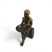 Painted bronze figure of seated African boy with bowl, h.19cm.
