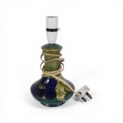 Moorcroft table lamp in the Clematis pattern on graduated green - blue ground. (H: 27cm)