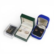 Three pairs of 9ct gold earrings, each set with semi precious stones.