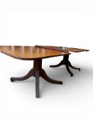 Mahogany twin pillar pedestal dining table with brass castors & leaf, measurements excluding leaf,