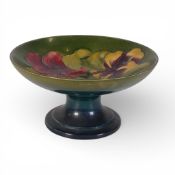 Moorcroft pedestal comport, hibiscus pattern on green ground, height 9cm, diameter 18cm.