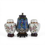 A pair of Oriental cloisonné miniature ginger jars, decorated with floral motifs on a white ground