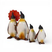 Beswick, family of penguins including one holding an umbrella, one with a walking cane and two