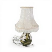 Moorcroft table lamp in the Bermuda Lily pattern on green ground. (H: 43cm with shade)