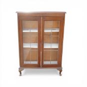 Oak double door leaded glass bookcase. Stands on cabriole legs. H114cm x W76cm