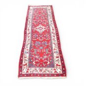 100% Wool Pile hall runner rug with recurring floral pattern of reds and navy's (L: 280cm x W: