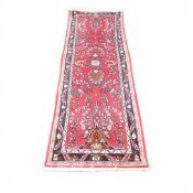 100% Wool Pile hall runner rug with recurring floral pattern of reds and navy's (L: 270cm x W: