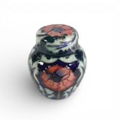Moorcroft lidded ginger jar in the Poppy design on dark blue ground, 1996, silver line through. (