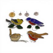 Stained glass and metal window mobile set decorated as various birds.