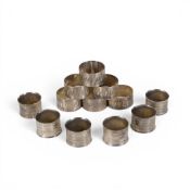 A set of six hallmarked Silver serviette rings, 190g together with another similar set of six