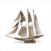 A vintage sailing boat, crafted from polished horn, and on a horn base. (H: 43cm x L: 50cm)