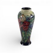 Moorcroft vase in the Simeone pattern on green to blue graduating ground, 1999. (H: 21cm)