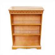 A vintage style wooden bookcase with decorative moulding along the top edge, H109cm x W77cm x D26cm.
