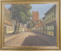 English cobbled street scene with a church in the background, oil on board, appears to be signed