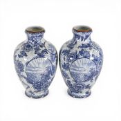 A pair of vintage Oriental-style vases, with blue and white decoration, depicting scenic landscape
