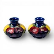 Pair of Moorcroft small squat vases, decorated in the Wisteria design, c1930, h.7.25cm. (2)