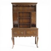 Early 20th century Welsh dresser with intricate carved details & brass hardware, H183cm x W108cm x