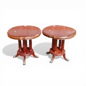 A pair of Theseira mahogany wine or lamp tables, with brass claw feet and carved pedestal legs. (
