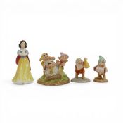 A collection of Royal Doulton Disney character figures including Snow White, Grumps Bath time