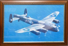A framed photograph depicting an Avro Lancaster bomber mid-flight over the sea. PA474 is one of