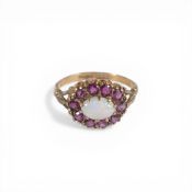 9ct gold ring set with centre opal stone surrounded by red stones, size N,2.4g.