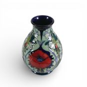Moorcroft footed vase in the Poppy pattern on blue ground, impressed marks and date 1996 in blue. (