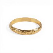 A yellow metal bangle, stamped to inner band NG22C RPM .25, diameter 7cm, approx. 26.7g.