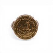 9ct gold ring with One tenth of ounce gold Krugerrand coin mounted, 6.8g.