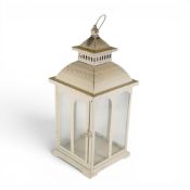 Vintage-style cream metal lantern with arched glass panes and decorative ornate detailing. (H:
