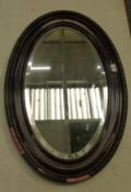 Edwardian mahogany-framed oval wall mirror with bevelled plate, 85cm x 57cm (Being sold in aid of