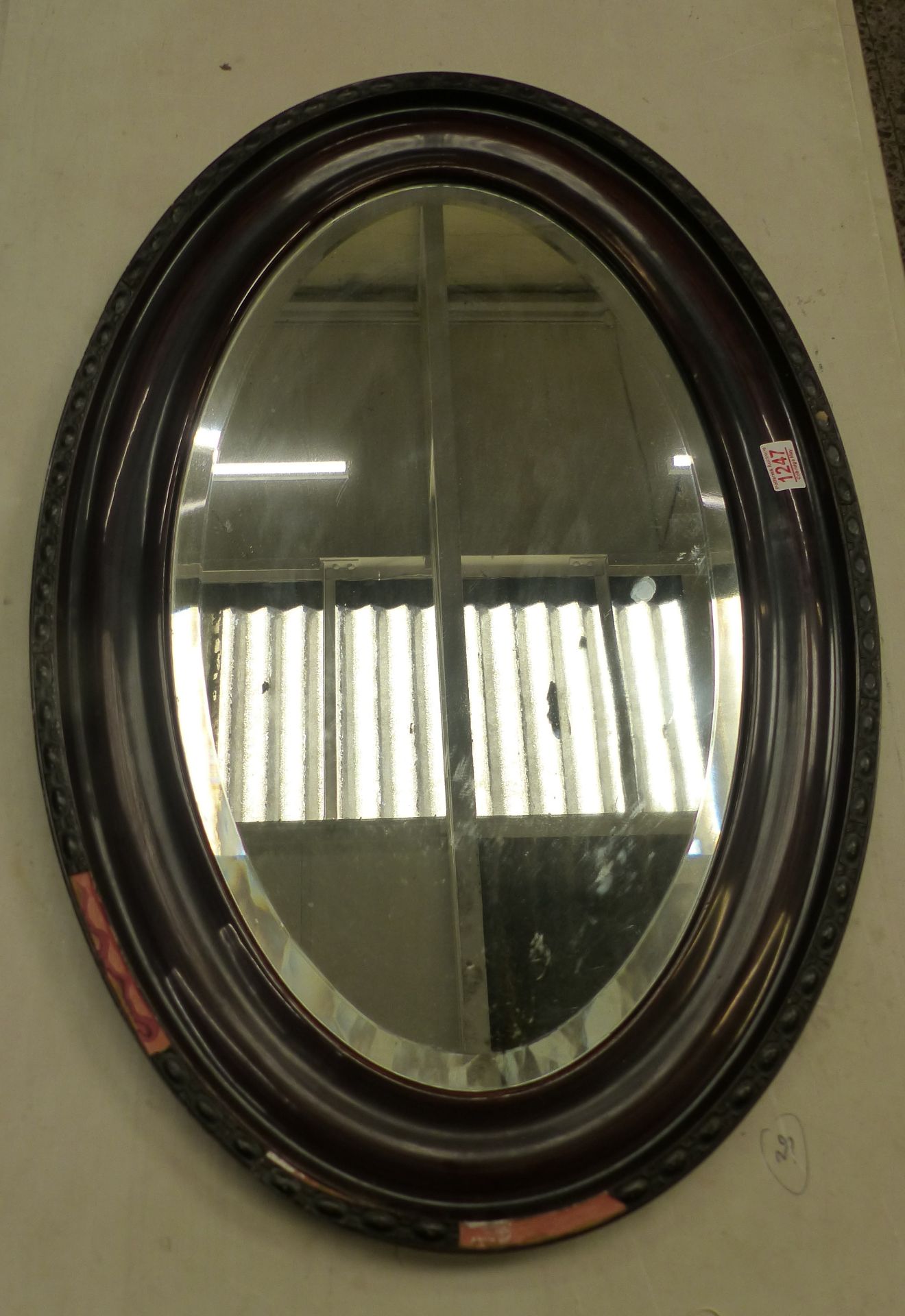 Edwardian mahogany-framed oval wall mirror with bevelled plate, 85cm x 57cm (Being sold in aid of