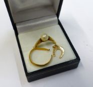 An 18ct gold ring (cut) with an 18ct horseshoe charm, combined 2.5g, together with a 14ct gold