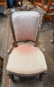 Carved walnut and fabric nursing chair on metal castors H85cm