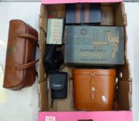 A mixed collection of items to include two pairs of cased binoculars, set of bowls, cast metal money